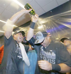 New York Yankees designated hitter Alex Rodriguez (left) pours champagne on teammate Carlos Beltran after the Yankees clinched a wild card berth in the playoffs by beating the Boston Red Sox 4-1 Thursday. 

AP Photo/Kathy Willens