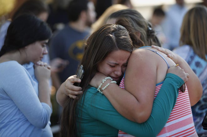 Jessica Vazquez (center) hugs her aunt, Leticia Alcaraz, as they await word on Alcaraz’s daughter in Roseburg after the attack at Umpqua Community College on Thursday. (Andy Nelson/The Register-Guard)