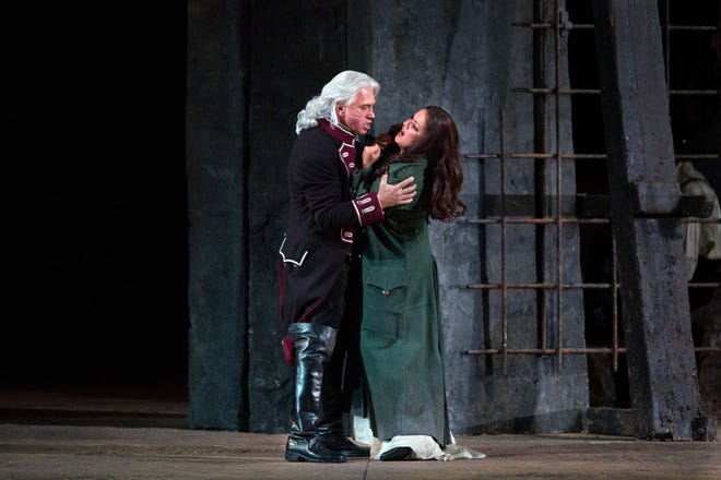 Soprano Anna Netrebko, right, and baritone Dmitri Hvorostovsky perform in a scene from Verdi's "Il Trovatore" at the Metropolitan Opera in New York. Metropolitan Opera via AP