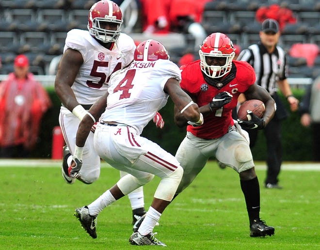 Georgia running back Sony Michel (1) tries to avoid a hit from Alabama defensive back Eddie Jackson (4) as Georgia takes on Alabama at Sanford Stadium on Saturday, Oct. 3, 2015 in Athens, Ga.