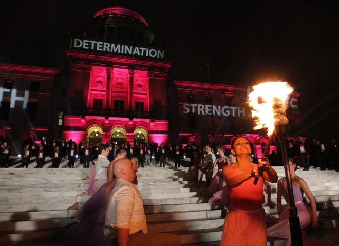 Members of the State Ballet of Rhode Island light the first torch of the Flames of Hope ceremony on Saturday night at the Rhode Island State House to celebrate life after cancer. The Providence Journal/Bob Breidenbach