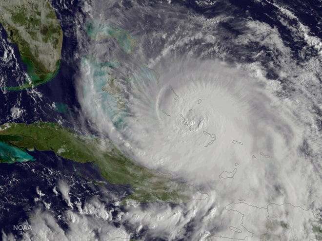 This satellite image taken Friday, Oct. 2, 2015 at 8:45 a.m. EDT, and released by the National Oceanic and Atmospheric Administration (NOAA), shows Hurricane Joaquin of the Bahamas. The Category 4 storm ripped off roofs, uprooted trees and unleashed heavy flooding as it hurled torrents of rain across the eastern and central Bahamas on Friday, and the U.S. Coast Guard said it was searching for a cargo ship with 33 people aboard that went missing during the storm. (NOAA via AP)