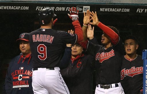 Cleveland's Ryan Raburn is congratulated after hitting a home run in the fourth inning.