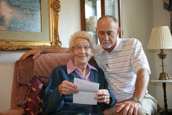 Mittie Byrne, left, and Joe Byrne look over a letter sent by Jenny Lancey from England. She was 6 when Sgt. Billy Byrne was an engineer in the D-Day invasion of Normandy during World War II.