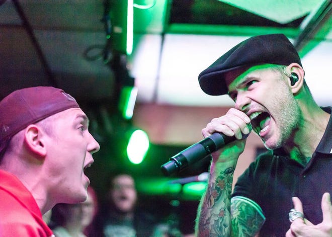 Audience member and friend of the band, Scott Richter (left) sings along with Dropkick Murphys lead singer Al Barr at the Beachcomber on Saturday night, the last night the club was open. 
Saturday, Oct. 3, 2015.