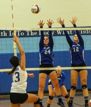 Somersworth's Hunter Gosselin (24) and Jamie Sharpe (12) try to block a shot by Oyster River's Isabelle Fradillada during their D-II match Monday evening in Durham. Photo by Shawn St.Hilaire/Fosters.com