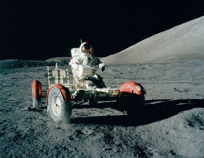 Apollo 17 Commander Eugene A. Cernan drives a Lunar Roving Vehicle (LRV) in a brief checkout prior to loading it with communications equipment, tools and scientific gear, during the early part of the first EVA at the Taurus-Littrow landing site. New rendering from a frame in Hasselblad film magazine 147/A, December 1972.