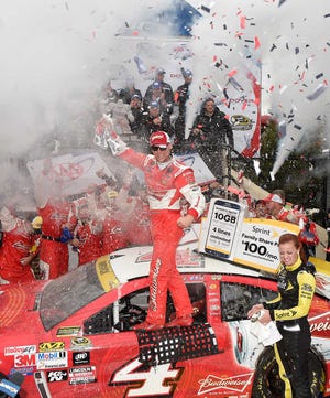 Kevin Harvick celebrates in Victory Lane after he won the NASCAR Sprint Cup series auto race, Sunday, Oct. 4, 2015, at Dover International Speedway in Dover, Del. (AP Photo/Nick Wass)