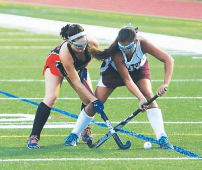 Photo by Jake West/New Jersey Herald — Carly Mahal of Hackettstown, left, battles Newton’s Lauren Barbato during Monday night’s field hockey game between the area’s two best teams, which ended in a 1-1 tie.