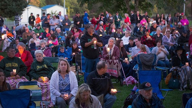 WINSTON, OR - OCTOBER 03: Residents of Douglas County attend a prayer service and candlelight vigil at River Bend Park to remember the victims of the mass shooting at Umpqua Community College in nearby Roseburg on October 3, 2015 in Winston, Oregon. On Thursday 26-year-old Chris Harper Mercer went on a shooting rampage at the college killing nine people and wounding another nine before killing himself. (Photo by Scott Olson/Getty Images)