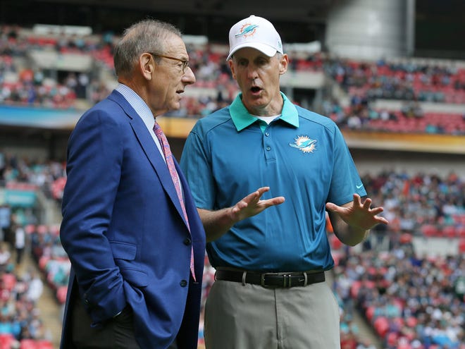 Miami Dolphins owner Stephen Ross, left, and Miami Dolphins head coach Joe Philbin chat during warm-ups before the NFL football game between the New York Jets and the Miami Dolphins and at Wembley stadium in London on Sunday.