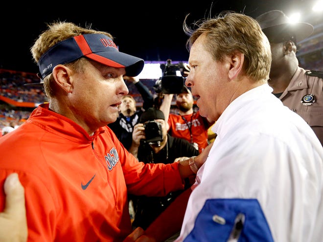 Florida coach Jim McElwain, right, shakes hands with Mississippi coach Hugh Freeze after the game at Ben Hill Griffin Stadium on Saturday. Florida defeated Mississippi 38-10.
