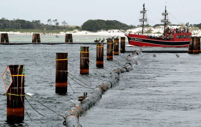 The Sea Dragon motors through the oil boom's open gate in the St. Andrew Bay pass in this file photo.