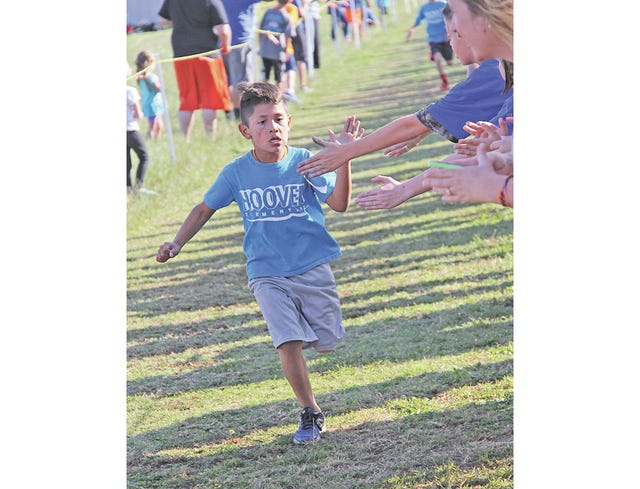 Hoover Elementary School second-grader Giovanni Robledo nears the finish line of last week’s Bruin Mile, put on by the Bartlesville High School cross country progam. Robledo burst to first in the boys third-grade-and-under division, with a time of 7:13.2. Approximately 450 youth from several elementary schools participated in one of the four divisions. Mike Tupa/Examiner-Enterprise 
 Hoover Elementary third-grader Breck Loudermilke surged to second place in the Bruin Mile third grade and under boys division. Mike Tupa/Examiner-Enterprise