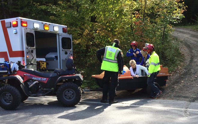 Emergency first responders assist a woman, center, as she is transferred to an ambulance from a trailer attached to an all-terrain vehicle near the site of an Amtrak train derailment, Monday, Oct. 5, 2015, in Roxbury, Vt. The Amtrak train, headed from Vermont to Washington, D.C., derailed in central Vermont on Monday after apparently striking rocks that were on the tracks about 20 miles southwest of the capital, Montpelier. (AP Photo/Wilson Ring)