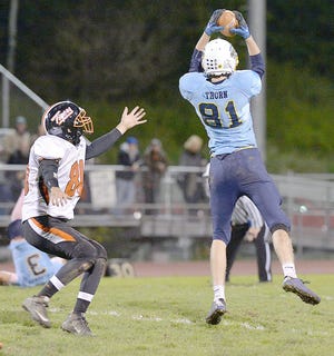 Central Valley Academy's James Thorn (81) makes a catch in front of a Mexico defender Friday. 

Photo Courtesy of Bob Critser, digitalsportsphotography.net
