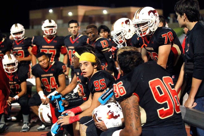 Coronado players discuss the game in a huddle on the sidelines. Coronado High played Hobbs High at Lowrey Field in Lubbock Friday evening. (Allison Terry/AJ Media)