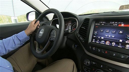 This image from video, taken Oct. 1, 2015, shows Insurance Institute for Highway Safety (IIHS) Senior Research Engineer David Aylor in the drivers seat with an electronic display on the dashboard at the IIHS Vehicle Research Center in Ruckersville, Va. American car buyers are baffled by a blizzard of new safety technologies in vehicles that vary from manufacturer to manufacturer, from model to model, and from one options package to another.