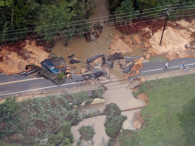 A truck rests off a washed out road outside of Columbia, S.C., Monday