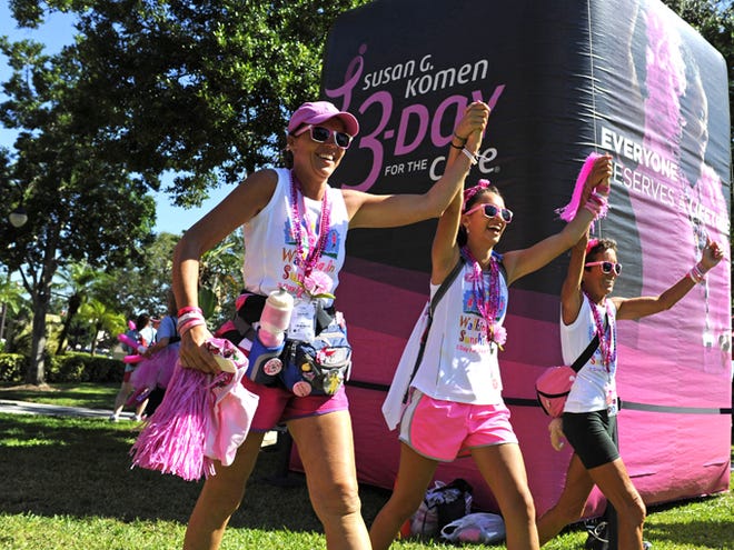 Members of the Walking in the Sunshine Training Team, from left, Kay Kouvatsos, her daughter Stephanie Kouvatsos, 17, and Carrie Seidman arrive at the finish line at Spa Beach Park as they conclude the Susan G. Komen 3-day, 60-mile walk for breast cancer on Sunday, Oct. 27, 2013, in St. Petersburg, Fla. (Oct. 27, 2013; Photo by: Brian Blanco)