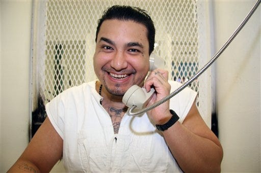 Death row inmate Juan Garcia is photographed in a visiting cage at the Texas Department of Criminal Justice Polunsky Unit near Livingston, Texas, during an interview on Sept. 2, 2015. Garcia, 35, from Houston, is facing execution Oct. 6, 2015, for the 1998 robbery and fatal shooting of Hugo Solano, 36. Evidence showed Garcia and three companions stole $8 from the victim. (AP Photo/Mike Graczyk)