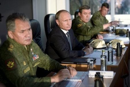 Russian President Vladimir Putin (C) with Defence Minister Sergei Shoigu (L) and armed forces Chief of Staff Valery Gerasimov observe troops in action during a training exercise at the Donguz testing range in Orenburg region, Russia, September 19, 2015. REUTERS/Alexei Nikolsky/RIA Novosti/Pool