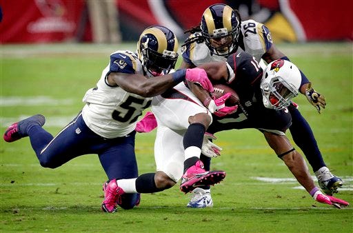 Arizona Cardinals running back David Johnson (31) his hit by St. Louis Rams outside linebacker Alec Ogletree (52) and safety Mark Barron (26) during the first half of an NFL football game, Sunday, Oct. 4, 2015, in Glendale, Ariz. (AP Photo/Ross D. Franklin)