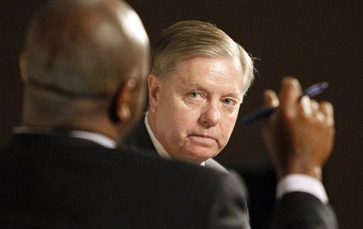 Sen. Tim Scott, left, hosts Republican presidential candidate Sen. Lindsey Graham, right, as part of his Tim's Town Halls series in Myrtle Beach, S.C., Monday, Sept. 28, 2015. Both voted against Hurricane Sandy relief. (Janet Blackmon Morgan/The Sun News via AP)