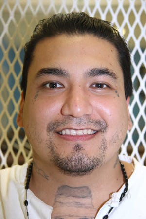 Death row inmate Juan Garcia is photographed in a visiting cage Wednesday, Sept. 2, 2015, at the Texas Department of Criminal Justice Polunsky Unit near Livingston, Texas. Garcia, 35, from Houston, is facing execution Oct. 6, 2015, for the 1998 robbery and fatal shooting of Hugo Solano, 36. Evidence showed Garcia and three companions stole $8 from the victim. (AP Photo/Mike Graczyk)