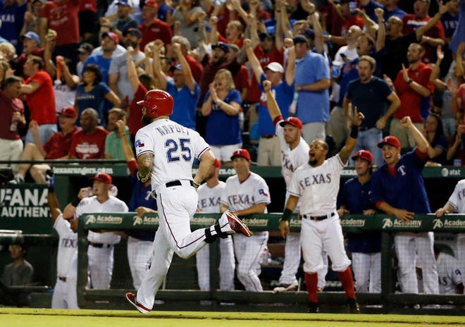 FILE - In this Sept. 30, 2015, file photo, Texas Rangers' Mike Napoli (25) runs the bases as the dugout celebrates following Napoli's two-run home run off of Detroit Tigers pitcher Matt Boyd in the third inning of a baseball game in Arlington, Texas. The Rangers are back in the playoffs two months after the return of Mike Napoli, who had 10 RBIs in their last World Series. (AP Photo/Tony Gutierrez, File)
