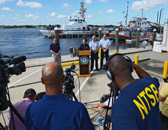 T. Bella Dinh-Zarr, Vice Chairman for the National Transportation Safety Board, answers questions about the search and investigation as Thomas Roth-Roffy, investigator in charge for the NTSB, left, and Capt. Mark Fedor, 2nd from right, chief of response, U. S. Coast Guard 7th District and Capt. Jason Neubauer, right, Chief for Office of Investigations and Casualty Analysis, U. S. Coast Guard listen, Wednesday, Oct. 7, 2015. The Coast Guard and NTSB held a news conference aboard Coast Guard Sector Jacksonville in regards to the missing Jacksonville-based cargo ship El Faro. (Bob Mack/The Florida Times-Union via AP)