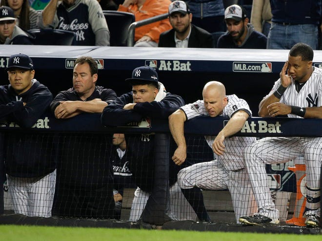 New York Yankees pitcher Masahiro Tanaka, far left, Dellin Betances, second from left, Brett Gardner, second from right, and Chris Young, right, watch from the dugout against the Houston Astros during the ninth inning of the American League wild card baseball game, Tuesday, Oct. 6, 2015, in New York. The Astros won 3-0 to advance to the American League Division Series.