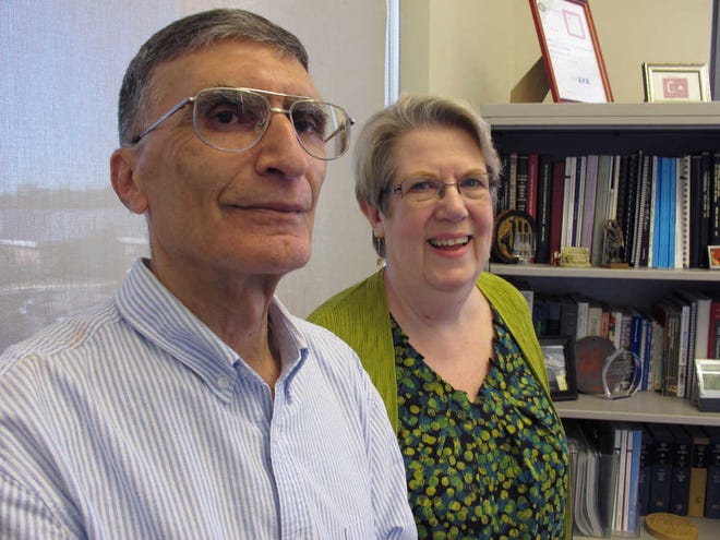 Dr. Aziz Sancar and his wife, Gwen, pose for a photo in his office at the University of North Carolina in Chapel Hill, N.C., on Wednesday, Oct. 7, 2015. Sancar and two other scientist won the Noble Prize for chemistry for work done in the 1970's and 1980's in DNA repair. Gwen Sancar, also a professor at UNC, took the call from the Nobel committee at 5 a.m., but says her husband didn't believe her initially. (AP Photo/Allen G. Breed)