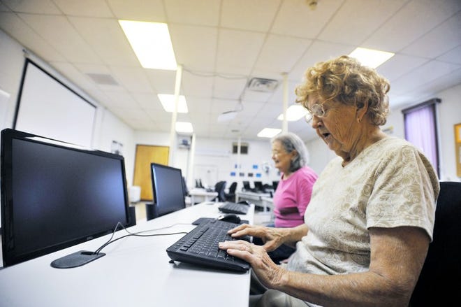 Morrisville Senior Servicenter members Dolly Annechini (front) and Carol Getty (back) work on computers in 2011.