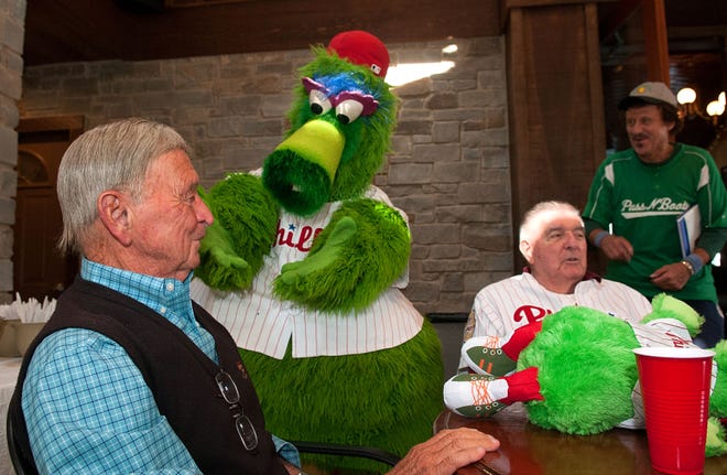 The Phillie Phanatic helps celebrate a belated birthday wish to baseball legend Bobby Shantz (left) of the Philadelphia Athletics/Phillies/Yankees, here with Curt Simmons (second from right). Senior league player Dick Sierota looks on at right.