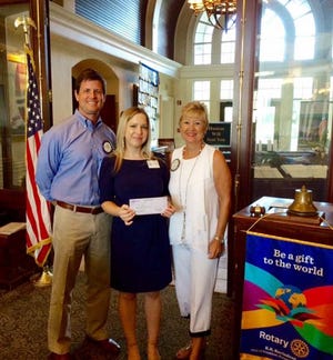 Dion Moniz, Destin Rotary District grant chair, Melanie Moore, education director for All Kinds of Art, and Marcia Hull, CEO MKAF, at the check presentation.