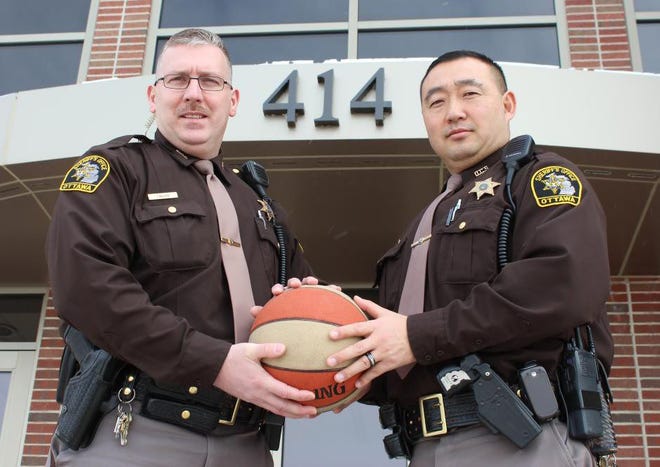 Ottawa County Sheriff’s deputies Dave Prout, right, and Joe Walker are shown in early March promoting a Deputy Sheriff’s Association fundraiser. Grand Haven Tribune file photo/Becky Vargo