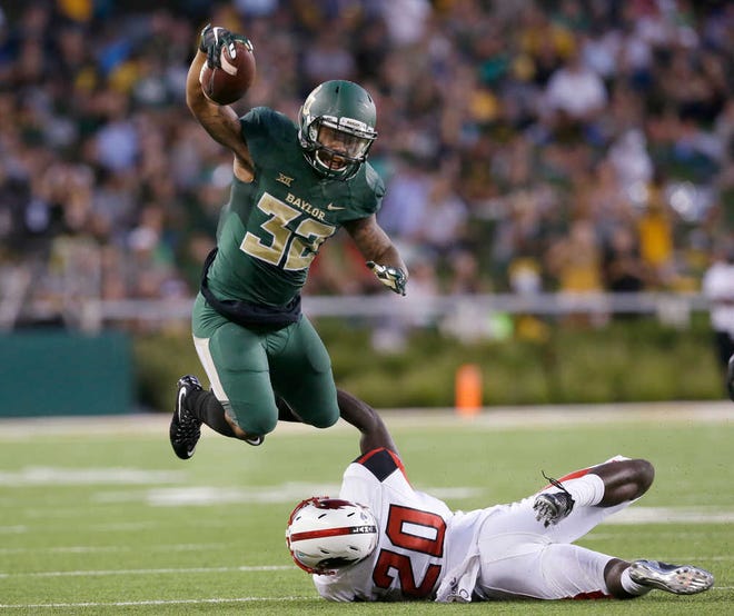 FILE - In this Sept. 12, 2015, file photo, Baylor running back Shock Linwood (32) jumps over Lamar defensive back Rodney Randle (20) during the first half of an NCAA college football game in Waco, Texas. Baylor, West Virginia, Texas Tech and TCU all have a 100-yard receiver and a 100-yard receiver. The rest of the power-five conferences have only one such team, plus Notre Dame.(AP Photo/LM Otero, File)