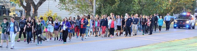 Accompanied by police escort, Shawnee students, teachers, parents and officials participate in International Walk to School Day. Wednesday morning, the group walks along Union Street toward Shawnee Middle School.