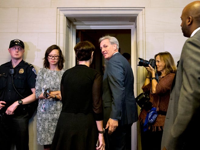House Majority Leader Kevin McCarthy of California, center, turns to his wife, Judy McCarthy, as they enter a House Republican caucus vote on its nominee to replace House Speaker John Boehner Thursday on Capitol Hill.