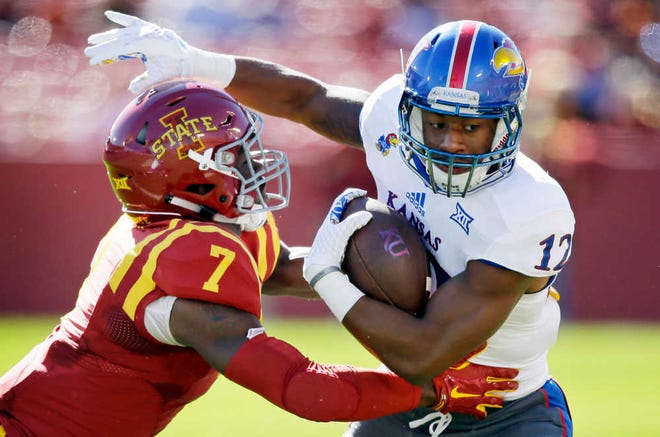 Kansas wide receiver Darious Crawley is tackled by Iowa State defensive back Qujuan Floyd after making a reception during the first half of an NCAA college football game, Saturday, Oct. 3, 2015, in Ames, Iowa. Iowa State won 38-13. (AP Photo/Charlie Neibergall)
