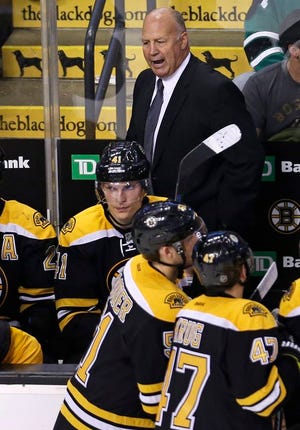 Boston Bruins head coach Claude Julien calls to his players in a timeout during the third period of an NHL hockey game against the Winnipeg Jets in Boston, Thursday, Oct. 8, 2015.