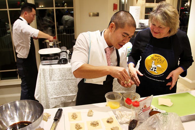 Jimmy Liang shows Marianne Peak, superintendent of the Adams National Historic Site, how to twist a dumpling. Local chefs took part in the fourth annual "Best Chef" cook-off, held at Granite Links Golf Course.
