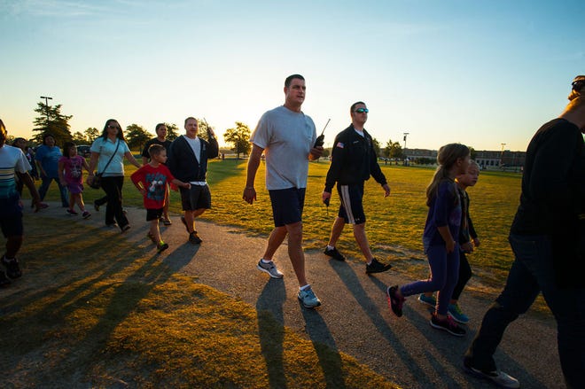 Stoney Point Elementary School celebrates International Walk to School Day, aimed at raising awareness of physical fitness, Oct. 8, 2014. Children, teachers and parents walked around track at sunrise as part of the event.