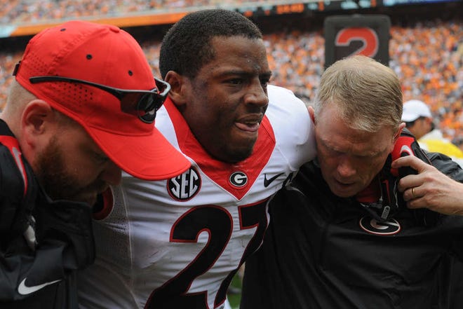Georgia running back Nick Chubb (27) is helped off the field after an injury during the first half of an NCAA college football game between Georgia and Tennessee on Saturday, Oct. 10, 2015, in Knoxville, Tenn. (AJ Reynolds/Staff, @ajreynoldsphoto)