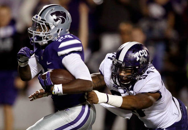 Kansas State running back Charles Jones (24) gets past TCU defensive end Josh Carraway (94) for a touchdown during the first half of an NCAA college football game in Manhattan, Kan., Saturday, Oct. 10, 2015. (AP Photo/Orlin Wagner)