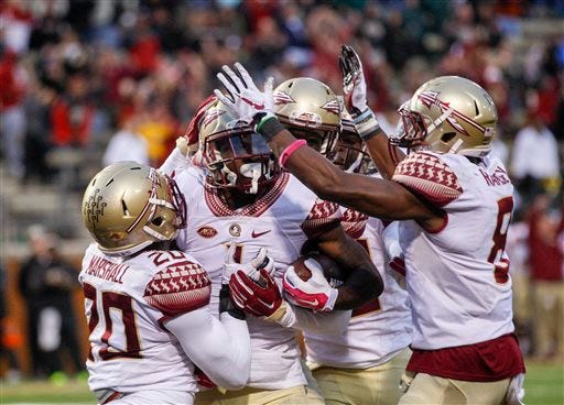 Florida State defensive back Tyler Hunter, second from left, celebrates with his teammates after he intercepted a pass in the end zone to clinch a win against Wake Forest in the final seconds of an NCAA college football game in Winston-Salem, N.C., Oct. 3, 2015. Florida State won 24-16. (AP Photo / Nell Redmond)
