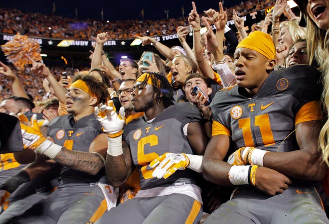 Tennessee quarterback Joshua Dobbs (11), running back Alvin Kamara (6) and Tennessee running back Jalen Hurd (1) celebrate after their team defeated Georgia won 38-31 in an NCAA college football game Saturday, Oct. 10, 2015, in Knoxville, Tenn.
