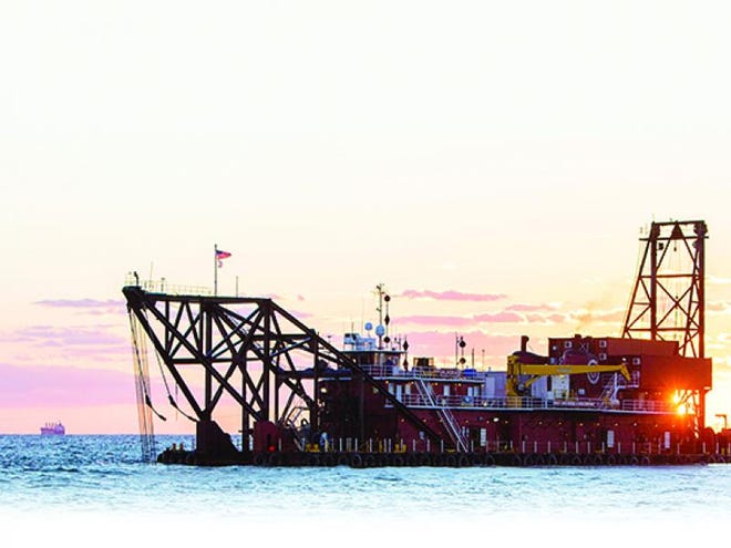 The Associated Press- At top, the 300-foot dredge Alaska deepens the shipping channel to the port of Savannah off the coast of Tybee Island.