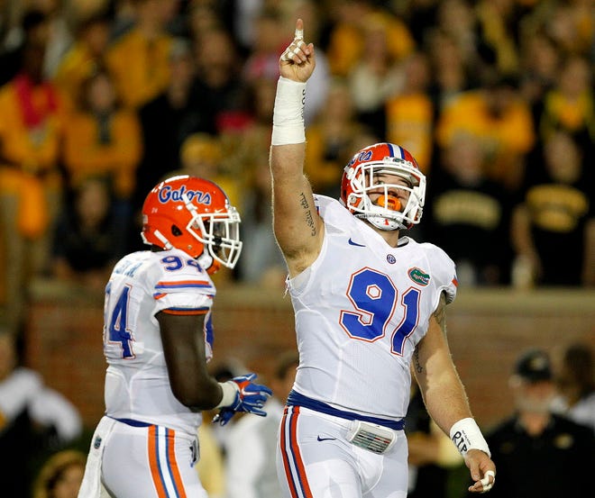 Florida Gators defensive lineman Joey Ivie (91) and defensive lineman Bryan Cox (94) celebrate after a sack against the Missouri Tigers during the first half at Faurot Field on Saturday, Oct. 10, 2015 in Columbia, Mo. Matt Stamey/Staff photographer